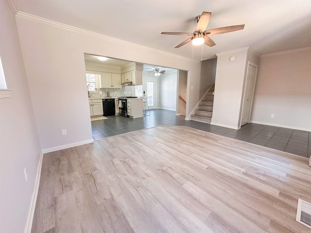 unfurnished living room featuring ceiling fan, light wood-type flooring, and ornamental molding