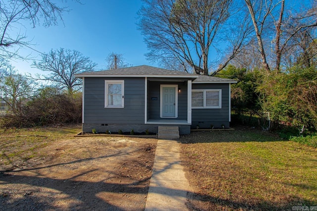 bungalow-style house with a front lawn