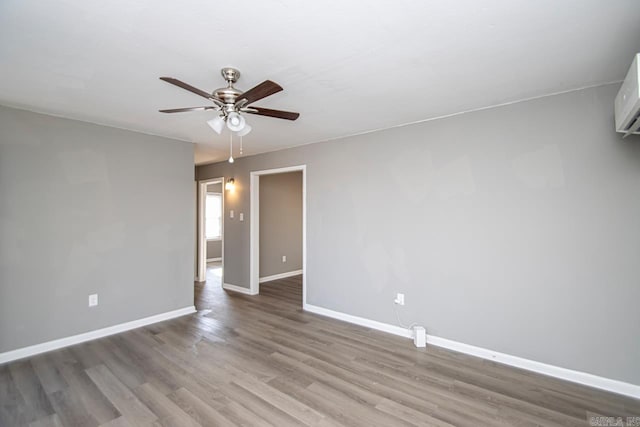 spare room with ceiling fan and wood-type flooring