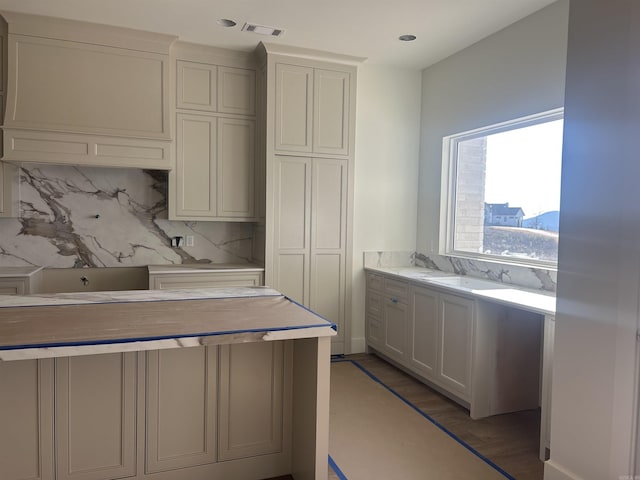 kitchen featuring tasteful backsplash and light hardwood / wood-style floors