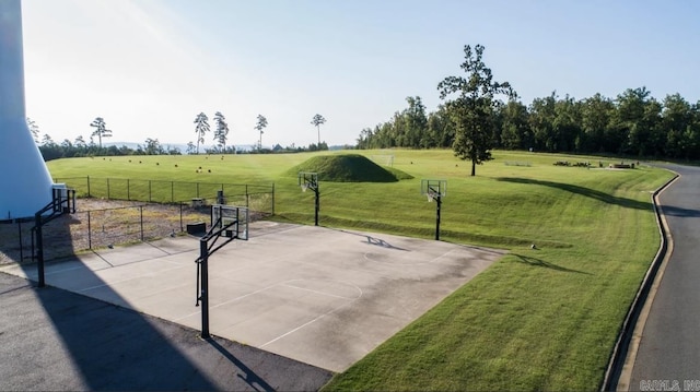 view of community featuring a yard and basketball hoop