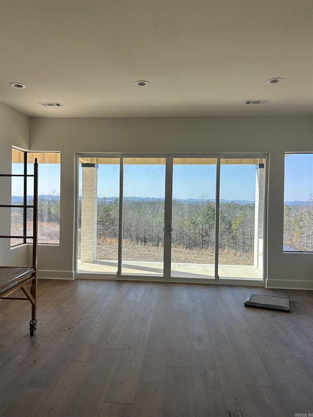 spare room with hardwood / wood-style floors