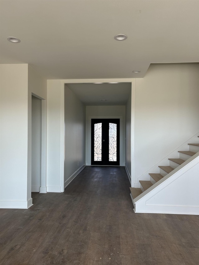 entryway with dark wood-type flooring and french doors