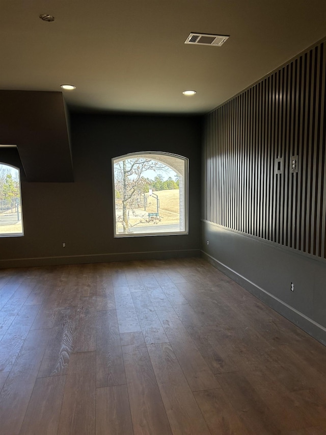 spare room featuring hardwood / wood-style floors and a wealth of natural light