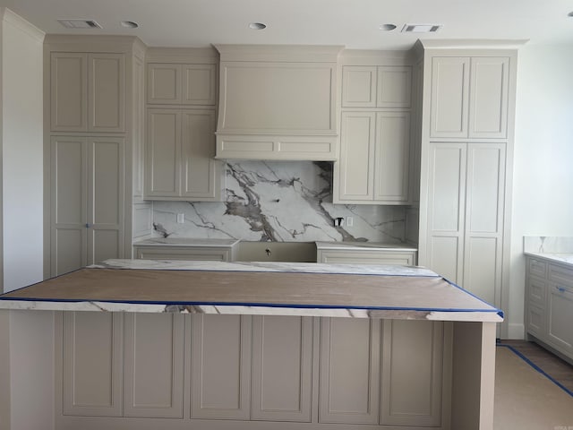 kitchen with tasteful backsplash and gray cabinets