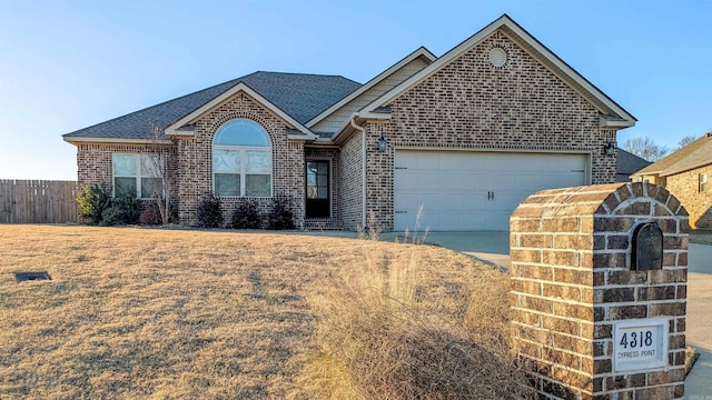 view of front facade with a garage and a front lawn