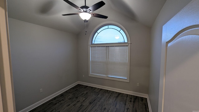 empty room featuring lofted ceiling, dark hardwood / wood-style floors, and ceiling fan