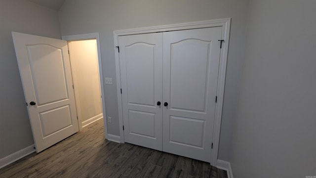 bedroom featuring dark hardwood / wood-style flooring and a closet