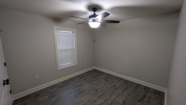 spare room with dark hardwood / wood-style floors and ceiling fan