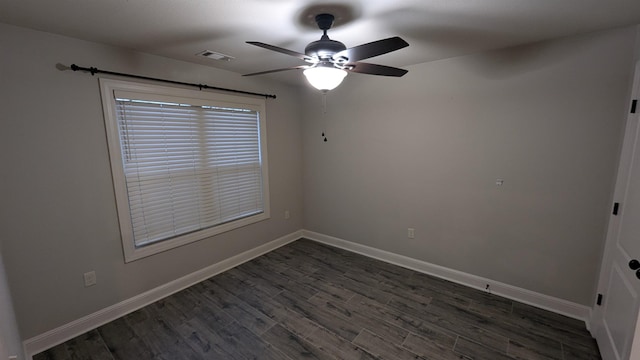 empty room with dark wood-type flooring and ceiling fan