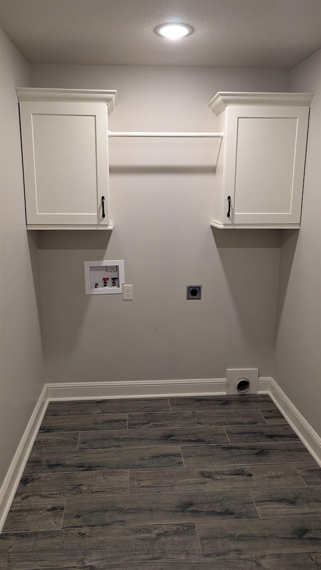 laundry room with dark wood-type flooring, cabinets, a textured ceiling, washer hookup, and hookup for an electric dryer