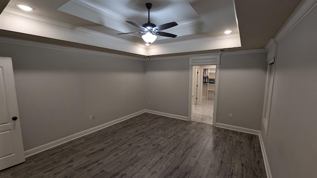 interior space featuring ornamental molding, dark hardwood / wood-style floors, and a tray ceiling