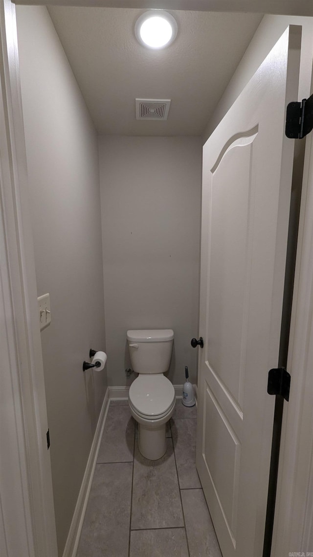 bathroom featuring tile patterned floors and toilet