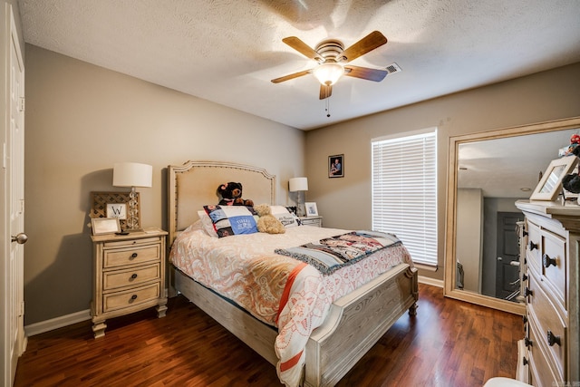 bedroom featuring ceiling fan, dark hardwood / wood-style flooring, and a textured ceiling