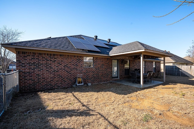 back of house with solar panels and a patio area