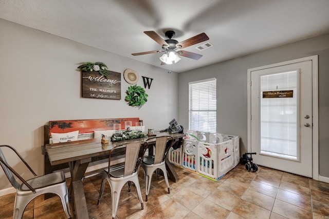 dining room featuring ceiling fan and light tile patterned flooring