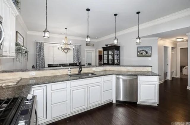 kitchen with white cabinets, sink, stainless steel appliances, and dark stone counters