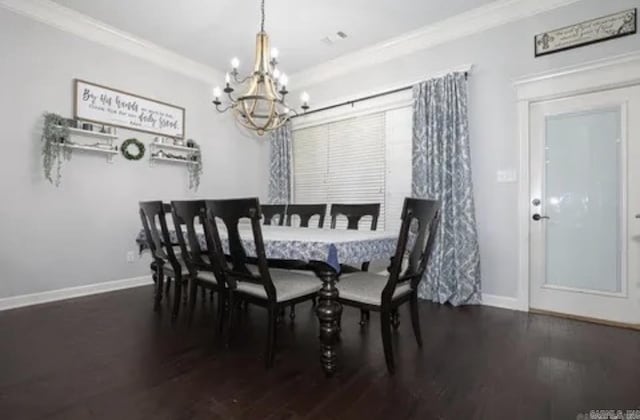 dining room featuring dark wood-type flooring, an inviting chandelier, and ornamental molding