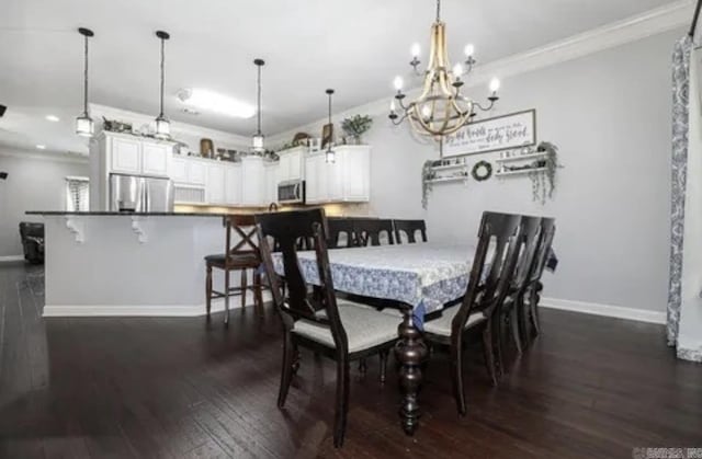 dining space featuring crown molding, dark hardwood / wood-style floors, and an inviting chandelier