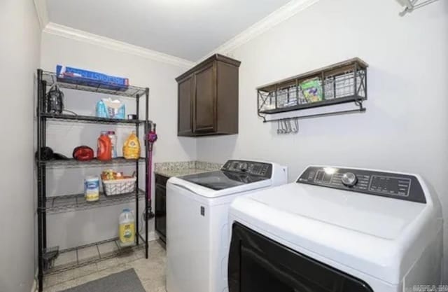 washroom featuring cabinets, ornamental molding, and washing machine and clothes dryer