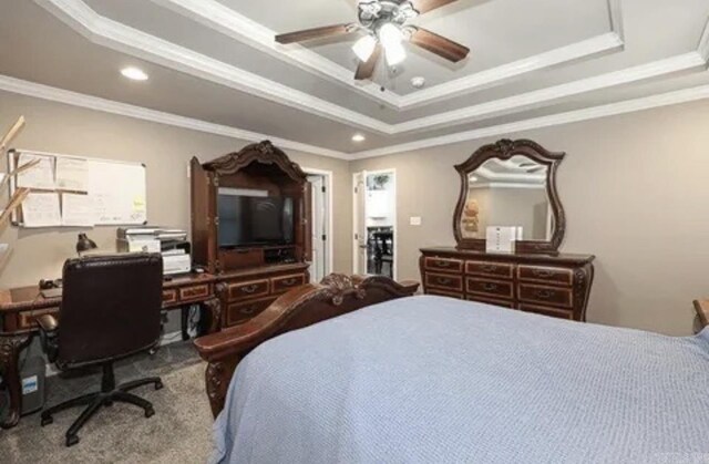 bedroom with a tray ceiling, crown molding, and ceiling fan