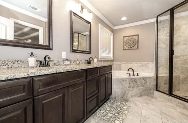 bathroom with vanity, ornamental molding, and independent shower and bath