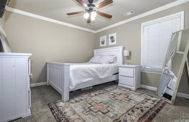 carpeted bedroom with ceiling fan and ornamental molding