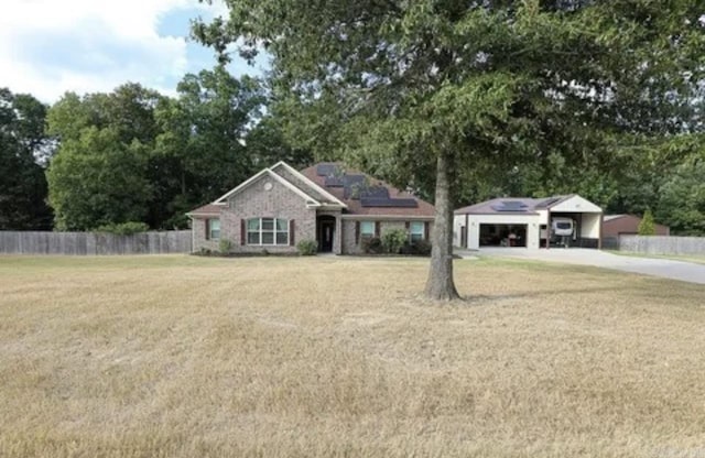 ranch-style home with a front lawn and a garage