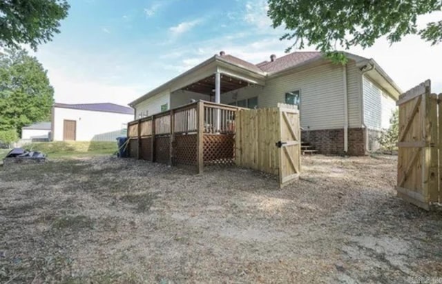 back of house featuring a deck