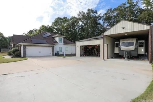 exterior space featuring a garage and solar panels