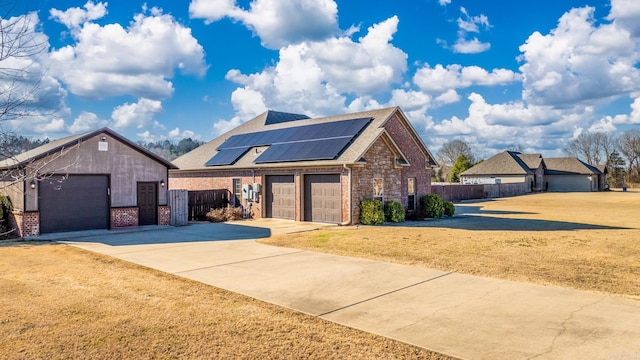 view of front facade featuring solar panels and a garage