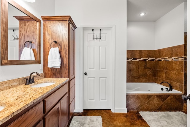 bathroom with a relaxing tiled tub and vanity