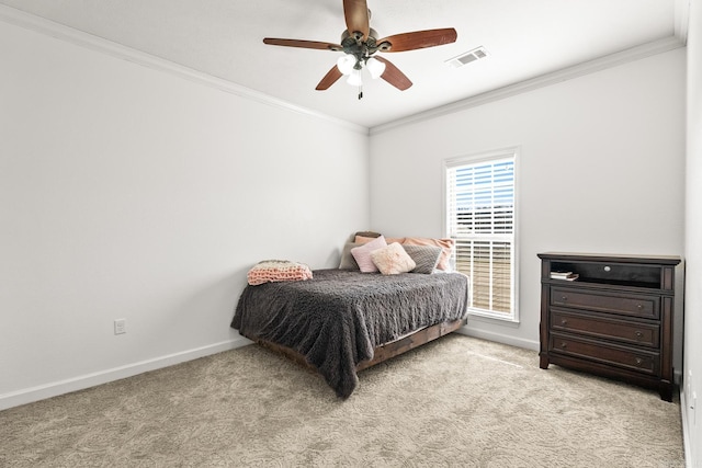 carpeted bedroom with ceiling fan and crown molding