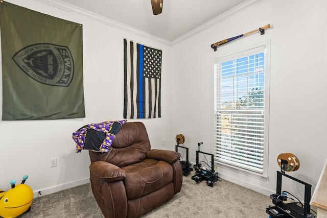 living area with carpet flooring, ceiling fan, and ornamental molding