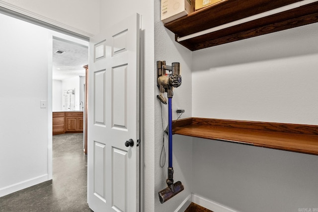 corridor featuring a textured ceiling