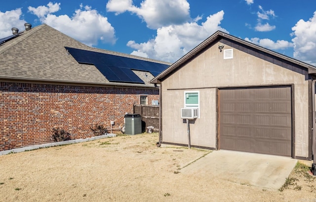 view of side of home with solar panels, cooling unit, and central air condition unit