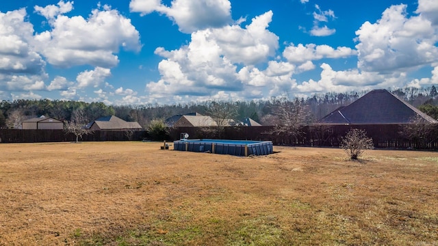 view of yard featuring a fenced in pool