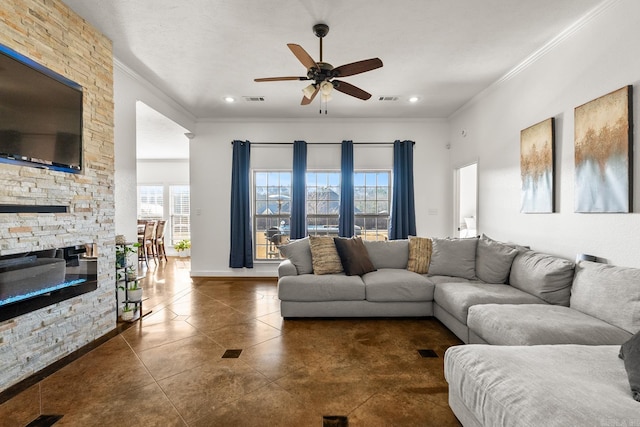 tiled living room featuring a stone fireplace, crown molding, and a healthy amount of sunlight