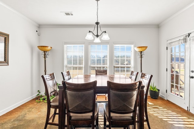 dining area with a chandelier and crown molding