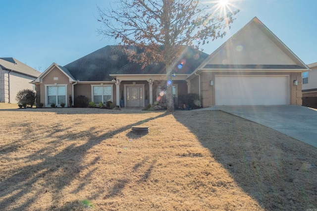 single story home with a garage and a front yard