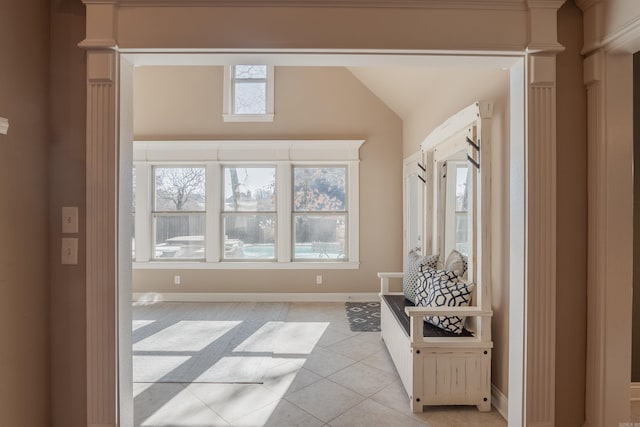 sitting room with light tile patterned flooring and vaulted ceiling