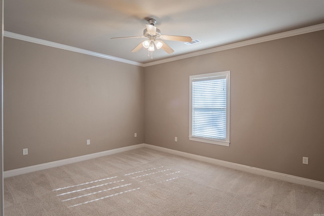 carpeted empty room featuring ceiling fan and crown molding