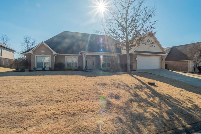 view of front of property with a front yard and a garage