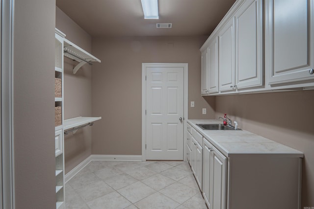 laundry area with light tile patterned flooring and sink