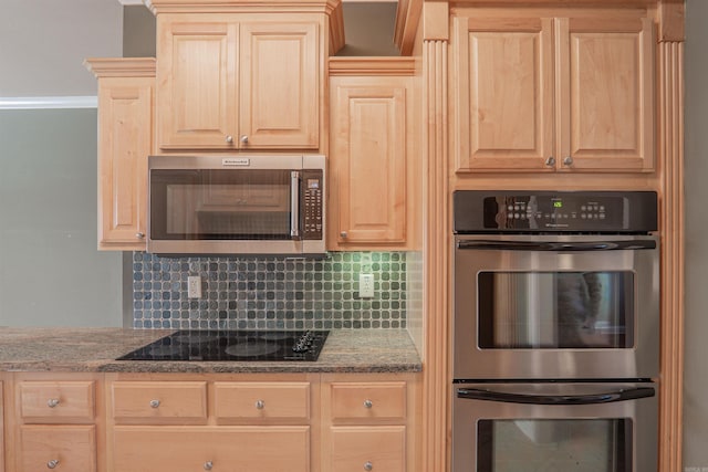 kitchen with backsplash, stone counters, light brown cabinetry, and stainless steel appliances