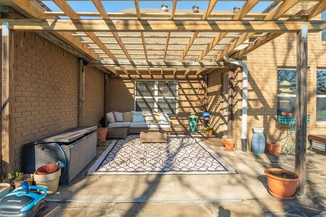 view of patio with an outdoor living space and a pergola