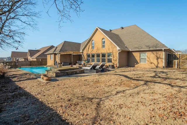 back of house featuring a fenced in pool and a patio area