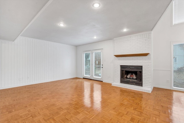 unfurnished living room with recessed lighting, a brick fireplace, visible vents, and baseboards