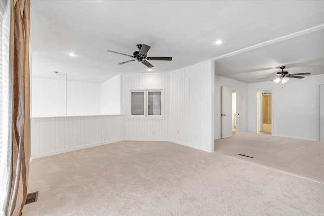 carpeted spare room featuring ceiling fan, visible vents, and recessed lighting