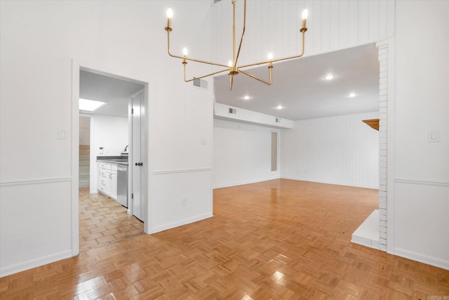 interior space featuring a chandelier, light parquet floors, and wooden walls